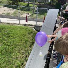 A purple balloon egg drop contraption