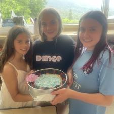 Girls displaying their cake